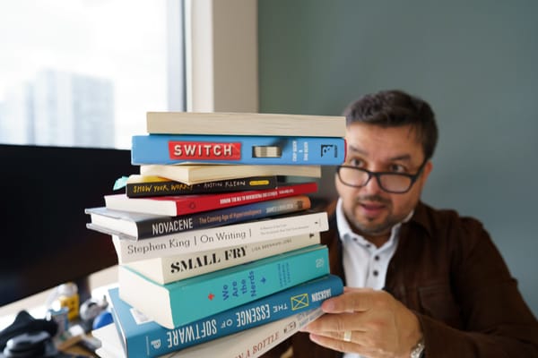 person holding many books